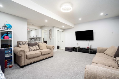 Carpeted living area with recessed lighting and baseboards - 43 1703 16 Avenue, Edmonton, AB - Indoor