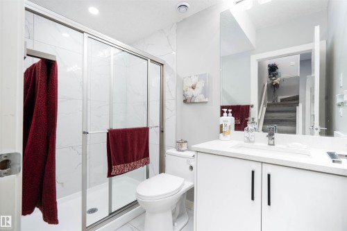 Full bath with vanity and a marble finish shower - 43 1703 16 Avenue, Edmonton, AB - Indoor Photo Showing Bathroom