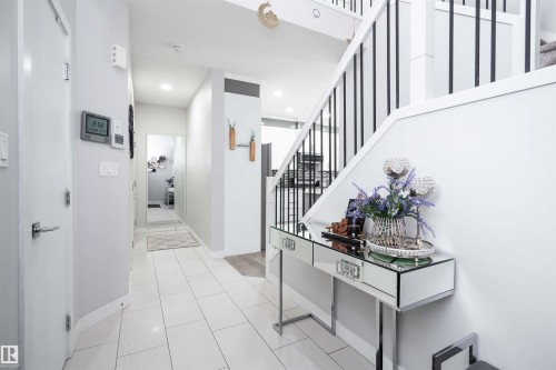 Hall featuring stairs and light tile patterned flooring - 43 1703 16 Avenue, Edmonton, AB - Indoor Photo Showing Other Room