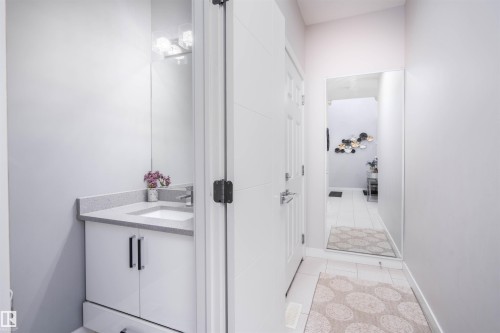 Bathroom featuring vanity and light tile patterned floors - 43 1703 16 Avenue, Edmonton, AB - Indoor Photo Showing Bathroom
