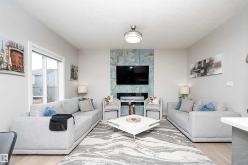 Living area with light wood-style floors - 43 1703 16 Avenue, Edmonton, AB - Indoor Photo Showing Living Room