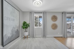 Entrance foyer with a textured ceiling and a baseboard radiator - 