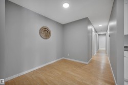 Corridor with recessed lighting and light wood-type flooring - 