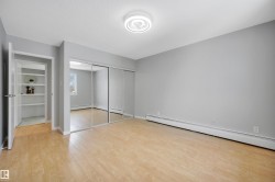 Unfurnished bedroom with a baseboard heating unit, light wood-style flooring, and a closet - 