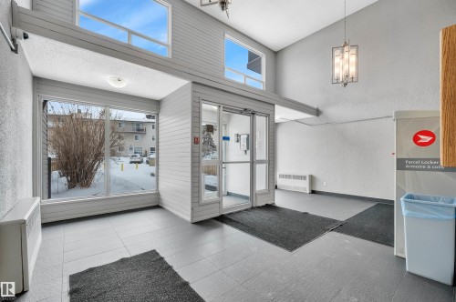 Building lobby with lofted ceiling and a textured wall - 201 237 Woodvale Road W, Edmonton, AB -  With Exterior