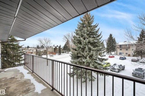 View of snow covered back of property - 201 237 Woodvale Road W, Edmonton, AB - Outdoor With Exterior