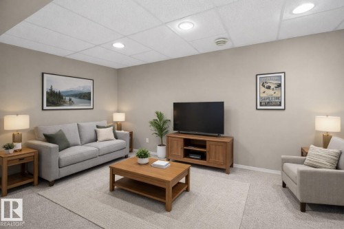 Living room featuring a drop ceiling, light carpet, and recessed lighting - 14648 54 Street, Edmonton, AB - Indoor Photo Showing Living Room