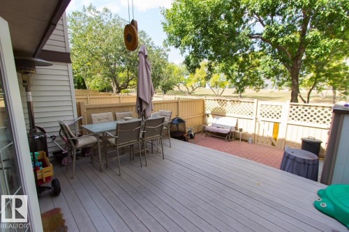 Wooden terrace featuring outdoor dining space and a fenced backyard - 14648 54 Street, Edmonton, AB - Outdoor With Deck Patio Veranda With Exterior