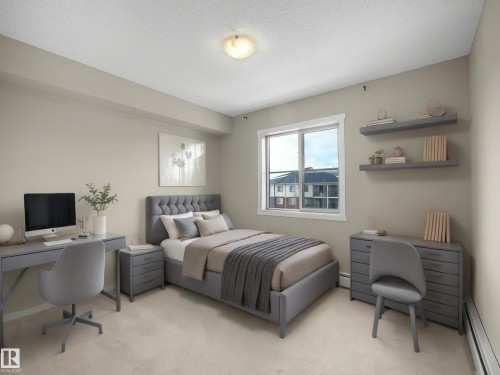Bedroom featuring baseboard heating, an office area, light carpet, and a textured ceiling - 422 5816 Mullen Place, Edmonton, AB - Indoor Photo Showing Bedroom