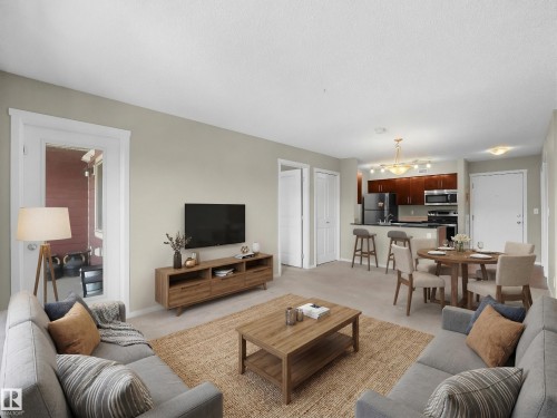 Living room with light carpet and baseboards - 422 5816 Mullen Place, Edmonton, AB - Indoor Photo Showing Living Room