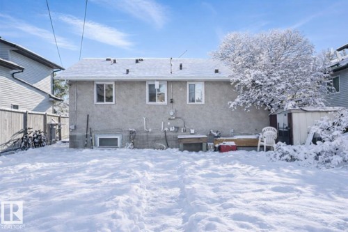 Snow covered property featuring a shed and stucco siding - 10505 154 Street, Edmonton, AB - Outdoor