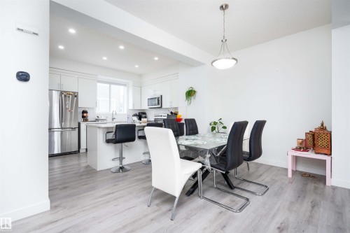 Dining space with recessed lighting and light wood-type flooring - 24 2072 Wonnacott Way, Edmonton, AB - Indoor Photo Showing Dining Room