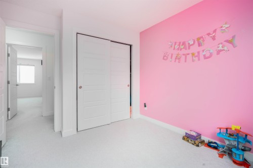 Unfurnished bedroom featuring light carpet and a closet - 24 2072 Wonnacott Way, Edmonton, AB - Indoor Photo Showing Other Room