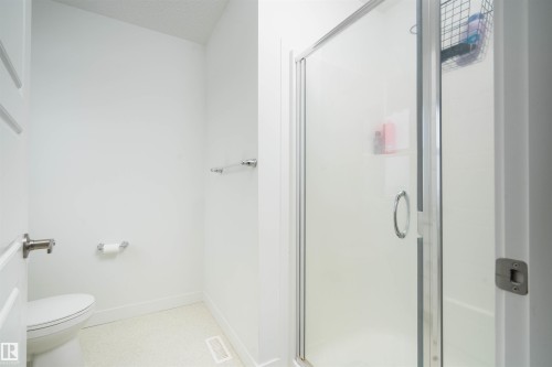 Full bath with a shower stall and a textured ceiling - 24 2072 Wonnacott Way, Edmonton, AB - Indoor Photo Showing Bathroom