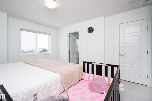 Bedroom featuring a textured ceiling and carpet flooring - 24 2072 Wonnacott Way, Edmonton, AB - Indoor Photo Showing Bedroom