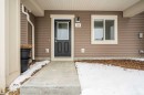 View of snow covered property entrance - 24 2072 Wonnacott Way, Edmonton, AB  - Outdoor With Exterior 