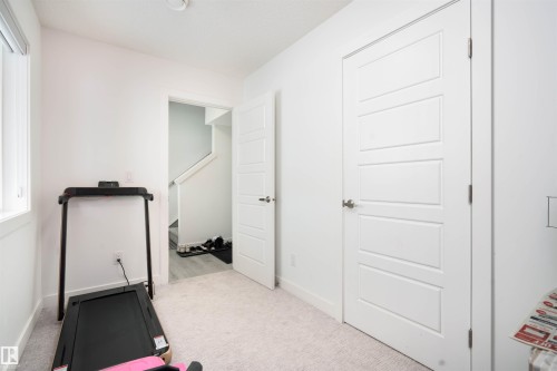 Workout area featuring light carpet - 24 2072 Wonnacott Way, Edmonton, AB - Indoor Photo Showing Gym Room