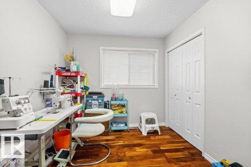 Office featuring dark wood-style floors and a textured ceiling - 11608 11A Avenue, Edmonton, AB - Indoor