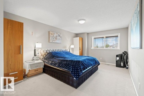 Bedroom with carpet floors and a textured ceiling - 11608 11A Avenue, Edmonton, AB - Indoor Photo Showing Bedroom