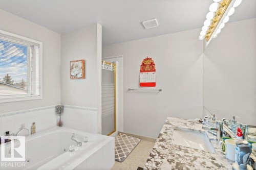Bathroom featuring a tub with jets, vanity, and a stall shower - 11608 11A Avenue, Edmonton, AB - Indoor Photo Showing Bathroom