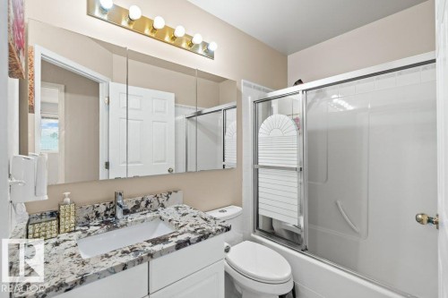Bathroom featuring combined bath / shower with glass door and vanity - 11608 11A Avenue, Edmonton, AB - Indoor Photo Showing Bathroom