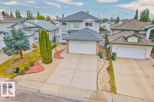 Traditional-style home featuring a garage, a residential view, and concrete driveway - 11608 11A Avenue, Edmonton, AB - Outdoor