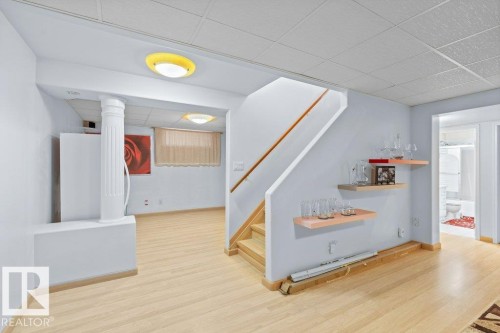 Stairs featuring a paneled ceiling and wood finished floors - 11608 11A Avenue, Edmonton, AB - Indoor Photo Showing Other Room