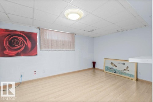 Finished basement with wood finished floors and a paneled ceiling - 11608 11A Avenue, Edmonton, AB - Indoor Photo Showing Other Room