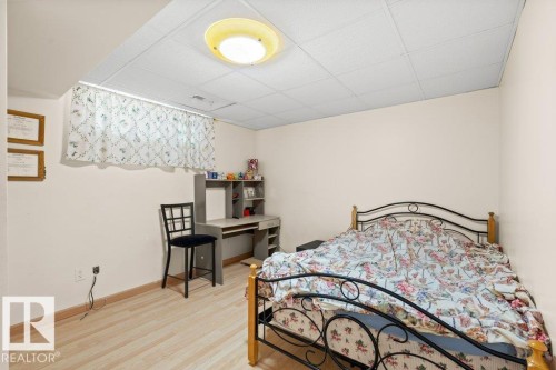 Bedroom featuring a paneled ceiling and light wood-style flooring - 11608 11A Avenue, Edmonton, AB - Indoor Photo Showing Bedroom