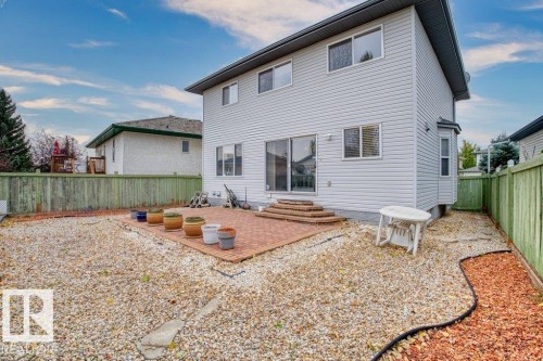 Back of house with a patio area, a fenced backyard, and entry steps - 11608 11A Avenue, Edmonton, AB - Outdoor With Exterior