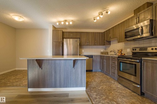 211 1820 Rutherford Road, Edmonton, AB - Indoor Photo Showing Kitchen With Stainless Steel Kitchen With Upgraded Kitchen