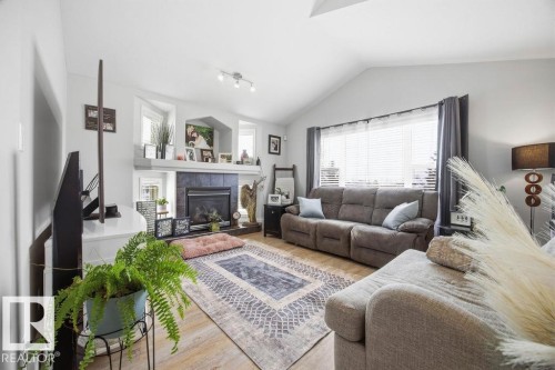 62 Pointe, Beaumont, AB - Indoor Photo Showing Living Room With Fireplace