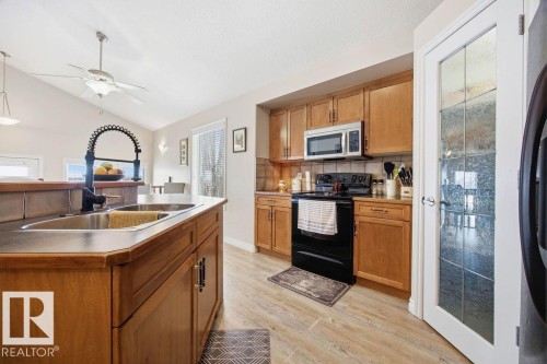 62 Pointe, Beaumont, AB - Indoor Photo Showing Kitchen With Double Sink