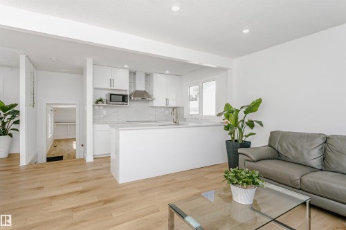 Living room with light wood-style floors and recessed lighting - 13520 113A Street, Edmonton, AB - Indoor