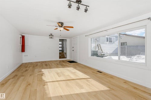 Unfurnished living room with a ceiling fan and light wood finished floors - 13520 113A Street, Edmonton, AB - Indoor Photo Showing Other Room