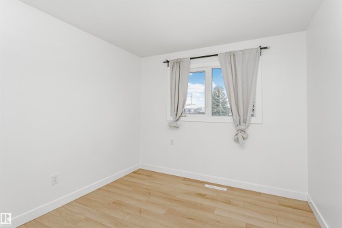 Spare room featuring light wood-style floors and baseboards - 13520 113A Street, Edmonton, AB - Indoor Photo Showing Other Room