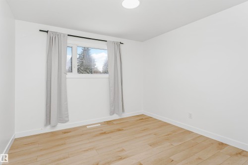 Spare room featuring light wood-type flooring and baseboards - 13520 113A Street, Edmonton, AB - Indoor Photo Showing Other Room