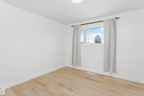 Unfurnished room with light wood-style floors and baseboards - 13520 113A Street, Edmonton, AB - Indoor Photo Showing Other Room