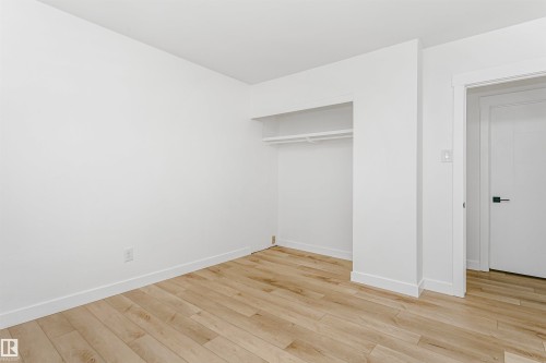 Unfurnished bedroom featuring light wood-type flooring and a closet - 13520 113A Street, Edmonton, AB - Indoor Photo Showing Other Room