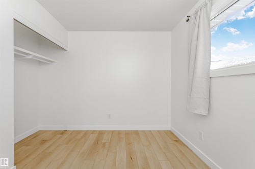 Spare room with light wood-type flooring and baseboards - 13520 113A Street, Edmonton, AB - Indoor