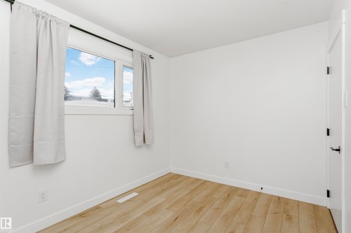 Empty room with baseboards and light wood-style flooring - 13520 113A Street, Edmonton, AB - Indoor Photo Showing Other Room