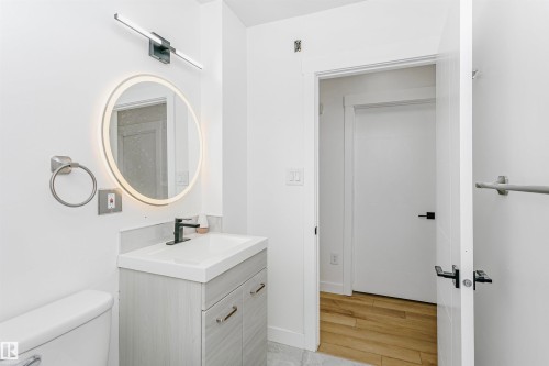 Half bath with vanity and light wood-type flooring - 13520 113A Street, Edmonton, AB - Indoor Photo Showing Bathroom