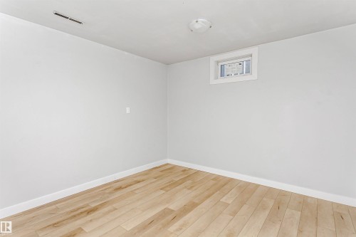 Unfurnished room featuring light wood-type flooring and baseboards - 13520 113A Street, Edmonton, AB - Indoor Photo Showing Other Room