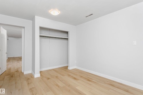Unfurnished bedroom with light wood-type flooring and a closet - 13520 113A Street, Edmonton, AB - Indoor Photo Showing Other Room