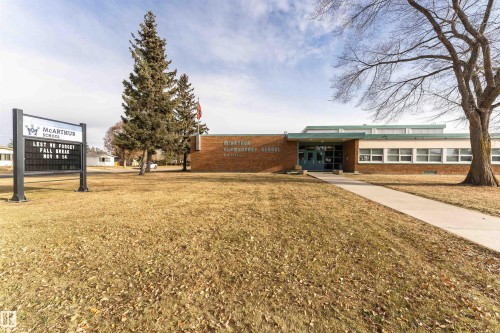 View of front of property featuring brick siding and a front lawn - 13520 113A Street, Edmonton, AB - Outdoor