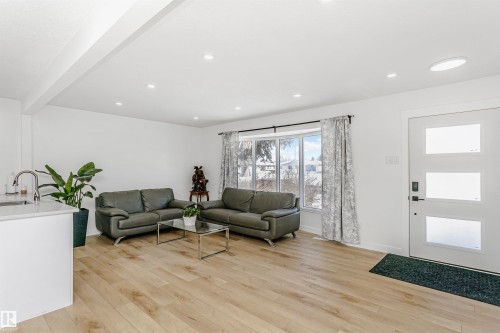Living area featuring light wood-style flooring, recessed lighting, and beam ceiling - 13520 113A Street, Edmonton, AB - Indoor Photo Showing Living Room