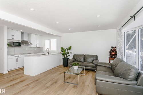 Living area featuring light wood finished floors and recessed lighting - 13520 113A Street, Edmonton, AB - Indoor