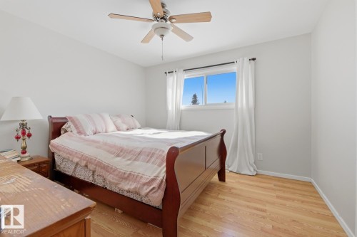 Bedroom with light wood-style floors and a ceiling fan - 11332 134 Avenue, Edmonton, AB - Indoor Photo Showing Bedroom