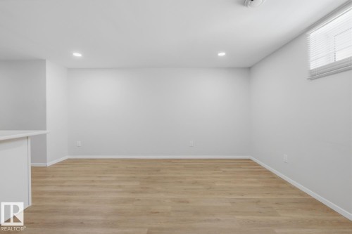 Below grade area with light wood-style floors and recessed lighting - 11332 134 Avenue, Edmonton, AB - Indoor Photo Showing Other Room