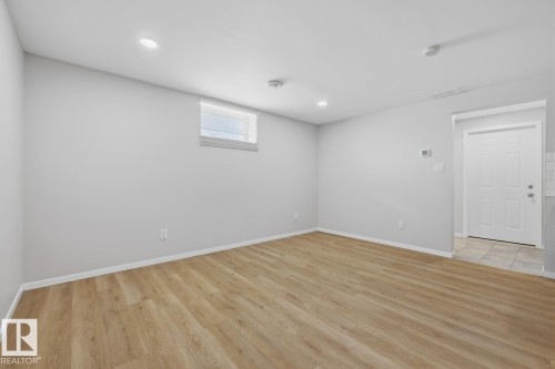 The property features light wood flooring, white walls, and recessed lighting - 11332 134 Avenue, Edmonton, AB - Indoor Photo Showing Other Room